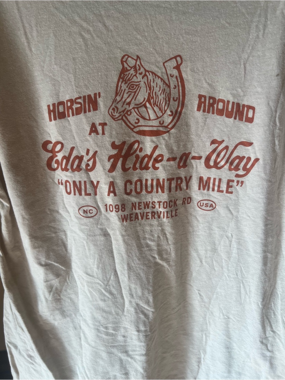 Next Level Apparel Cream T‑Shirt with Rust Red Vintage Horse Graphic